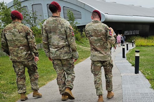 Brick-Project-2 Soldiers walking along Brock Project walkway in Normandy