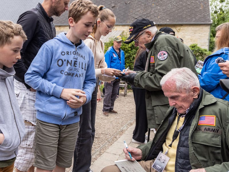 Foundation-Mission-Statement Veteran signing autographs for young kids